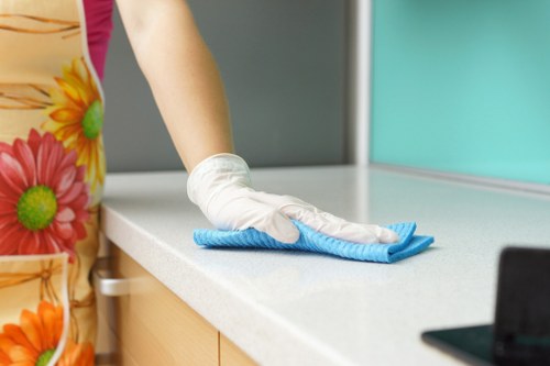 Technician performing commercial carpet cleaning in workplace